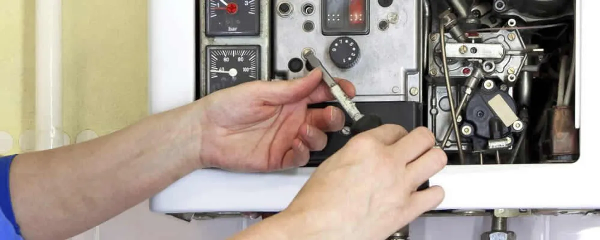 Heating repair technician adjusting boiler controls and components in La Jolla, CA