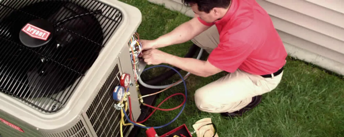 HVAC technician servicing an outdoor air conditioner unit in La Jolla, CA