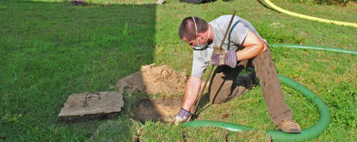 Septic pumping technician servicing a residential septic tank in La Jolla, CA